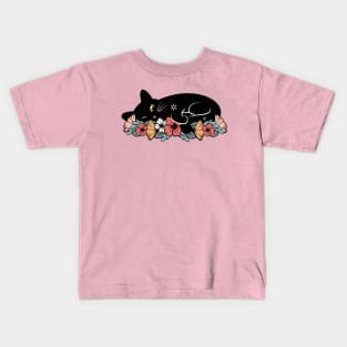 Cute black cat on a bed of flowers Kids T-Shirt